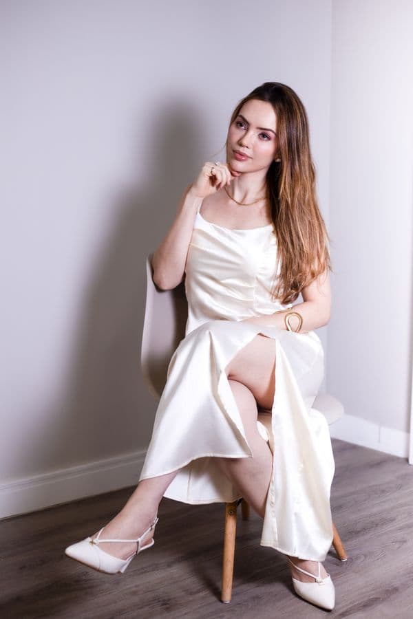 A cream satin dress in flat daylight